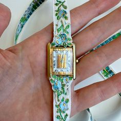 Our 2nd and Final Garden Party Vintage Wrap Watch features a vintage Must De Cartier Tank Quartz Watch circa the 1990s, reimagined with a feminine brocade ribbon designed to be wrapped multiple times around the wrist and tied off for a truly one of a kind look. This watch comes with both the blue/green ribbon AND the black/pink ribbon. Sterling Silver base with gold plating. Highly unique mixed metal Trinity Dial. Quartz Movement. Sold as is, plating has wear on the dial that adds to the piece's Vintage Gold Jewelry And Watches With Bracelet Strap, Luxury Vintage Watch Bracelet Strap, Vintage Adjustable Cuff Watch, Vintage Collectible Cuff Bangle Bracelet, Vintage Multicolor Quartz Watch, Vintage Fine Jewelry, Cartier Tank, The 1990s, Ribbon Design