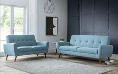 a living room with two blue couches and a rug