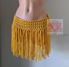 a mannequin wearing a yellow crochet skirt with fringes on it