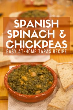 a bowl of spinach and chickpeas next to some bread on a table