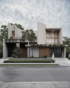 a person walking down the street in front of a house