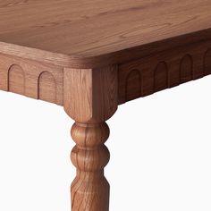 a close up of a wooden table with no one around it on a white background