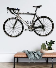 a bicycle mounted to the wall above a bench