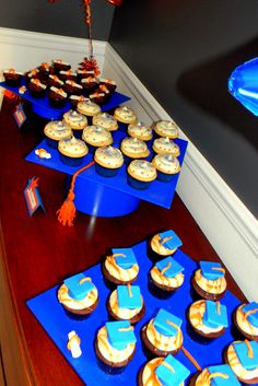 cupcakes on blue trays with graduation decorations