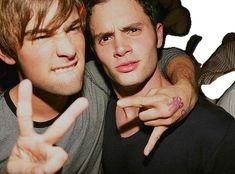 two young men posing for the camera with their fingers in the shape of peace signs