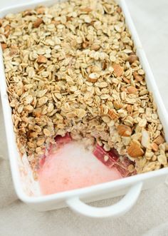 a close up of a dish of food with oats and strawberries in it