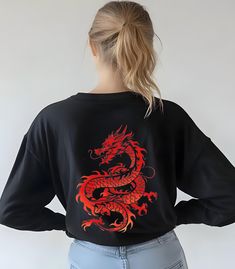 Red Dragon Long Sleeve T-Shirt, Red Dragon Shirt Chinese Zodiac Lunar Year of the Dragon T-shirt Gift, Red Dragon Birthday Gift Tee Custom Designed Red Dragon Long-Sleeve T-shirt. Design on back of shirt. Front is blank. Item Details: -100% ring-spun cotton -Medium fabric (6.1 oz/yd² (206.8 g/m -Unisex Garment-dyed Long Sleeve T-Shirt Comfort Colors® 6014 Made with 100% ring-spun cotton, these long-sleeve shirts come packed with softness and style. Each tee features garment-dyed fabric and comes with a relaxed fit for total comfort in any casual setting.  Machine wash: cold (max 30C or 90F); Do not bleach; Tumble dry: low heat; Iron, steam or dry: low heat; Do not dryclean. Shop Policies: 📦This product is made to order once you place an order, which is why it takes us a bit longer to deli Dragon Shirt, Lunar Year, Dragon Birthday, Year Of The Dragon, Chinese Zodiac, Red Dragon, Dyed Fabric, The Dragon, Comfort Colors