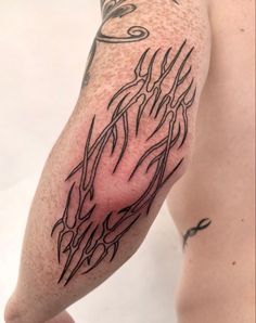 a man's arm with tattoos on it and an arrow in the middle of his arm