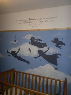 a baby's crib with a mural on the wall