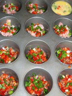 twelve pans filled with different types of food