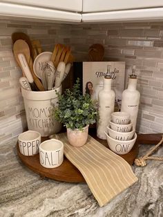 kitchen utensils are arranged on a wooden tray