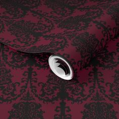 a red and black wallpaper with an ornate design on it's surface,