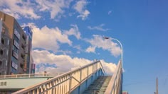 the sky is blue and there are many buildings in the background with stairs leading up to them