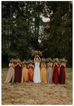 a group of women standing next to each other in front of trees