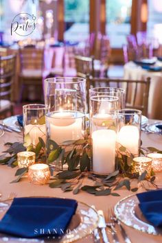 a table with candles and place settings on it