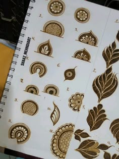 an image of hendi designs on a sheet of paper with scissors and glues