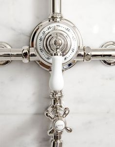 the cross is made up of silver and white marble