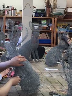 several people are working on some glass animals