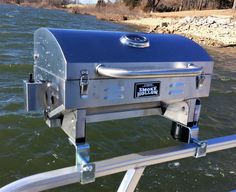 an outdoor grill on the side of a boat