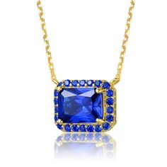 14k Yellow Gold Plated with Radiant Cut Blue Sapphire Cubic Zirconia Solitaire Halo Petite Pendant Necklace. Add vibrancy to your day or night wardrobe with this stunning 14k yellow gold plated necklace. A rectangular/radiant cut blue sapphirecubic zirconias (September Birthstone). A shiny cable chain connected on each side of this glamorous pendant allows it to sit centered when worn, gracing the collarbone and securing by a lobster clasp. Fine Jewelry Gold Ring With Lab-created Sapphire, Gold Jewelry With Lab-created Sapphire For Anniversary, Gold Birthstone Jewelry With Lab-created Sapphire, Gold Jewelry With Lab-created Sapphire Birthstone, Royal Blue Cubic Zirconia Jewelry Gift, Brass Pendant Necklace, September Birthstone, Radiant Cut, Accessories Jewelry Necklace