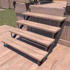 three wooden benches sitting on top of a wooden deck next to grass and building materials