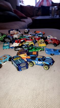 there are many toy cars on the floor