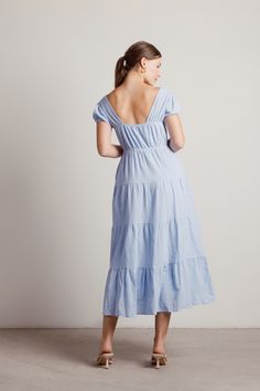 "The Misty Textured Cotton Tiered Midi Dress In Blue Is Your New Best Friend. This A-Line Midi Dress Features A Square Neckline, Short Puffy Sleeves, And A Tiered Skirt. Wear This Dress To Summer Picnic Dates, Brunch Dates, Or Engagement Parties." Light Blue Tiered Midi Dress, Picnic Dates, Short Puffy Sleeves, Brunch Dates, Picnic Date, Engagement Parties, Breezy Dress, Tiered Midi Dress, Dress Inspo