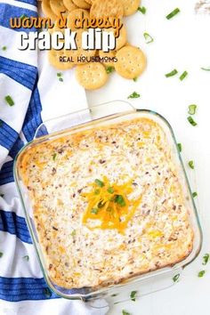 a casserole dish with cheese and crackers on the side