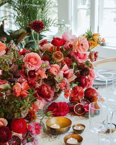 a table topped with lots of flowers and candles