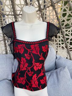 Vintage Corset Top Rich & Vibrant Red & Black corset 1940's Victorian style. OOAK A very unique piece of clothing to come by. If you like unique  then this is definitely onw you should get. Pair this beautiful top with a skirt, jeans or amp it up with your imagination. US size 8 or Medium The bustier top is embroidered and not printed. The corset doesn't have bones (Hard strips of material) It is soft but has a unique form due to impeccable tailoring. Length of Corset from Neck to bottom edge 14 inches Height of sleeve 6 inches Waist 32 inches. Zip fastener on the side for ease of wear. The material is a brocade type heavy material and has no stretch in it. Comes from my own vintage collection, a pet free and smoke free environment. Red Evening Corset With Boned Bodice, Fitted Summer Corset For Cocktail, Fitted Summer Corset For Cocktail Occasions, Summer Cocktail Fitted Corset, Summer Cocktail Corset Fitted, Vintage Fitted Corset With Square Neck, Vintage Sleeveless Evening Corset, Vintage Square Neck Fitted Corset, Red Fitted Top With Boned Bodice