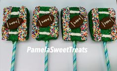 four football lollipops decorated with sprinkles and frosting on sticks