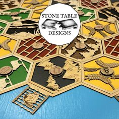 a wooden table topped with lots of different types of game boards and tokens on top of each other