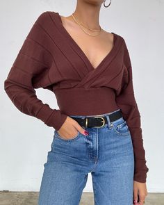 This lightweight brown-toned sweater features a deep v-neckline, long puff sleeves, and a fitted waist. Wear it on or off the shoulders with a bralette and gold jewelry for the perfect look. More Details - Looser fit at the top with a fitted waist - Does stretch - True to size - Cropped hem - Color may vary due to the lighting - Model is wearing a size small Model Details Height 5'7 | Chest 34" Waist 27" Hips 36.5" | Weight 118lbs | Wears a US size small in tops and dresses. SIZE GUIDE SMALL MED Chic Brown V-neck Top, Trendy V-neck Crop Top For Fall, Winter V-neck Crop Top For Night Out, V-neck Crop Top For Winter Night Out, V-neck Crop Top For Night Out In Winter, V-neck Crop Top For Night Out, Elegant Brown V-neck Sweater, Brown V-neck Crop Top, Brown V-neck Tops For Fall