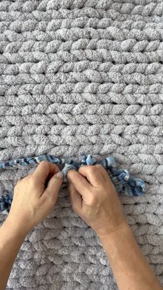 someone is crocheting the ends of a blanket