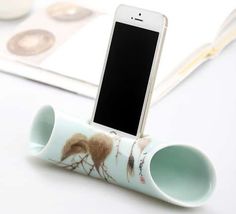 a cell phone in a cup holder on a table