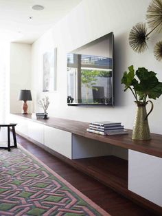 a living room with a large mirror on the wall