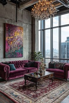 a living room filled with purple couches and a chandelier hanging from the ceiling