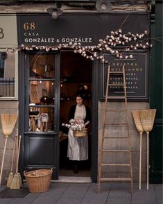 a woman standing in the doorway of a store