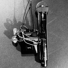 two microphones are sitting on the floor next to each other with wires attached to them