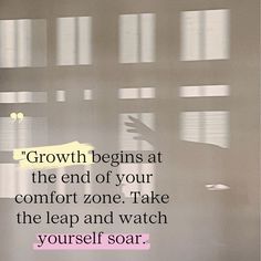 a person standing in front of a window with the words growth begins at the end of your comfort zone take the leap and watch yourself soar