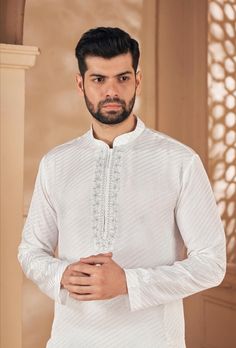 *PRODUCT DETAILS:- Get an absolute regal look apt for any event in this basic white cotton kurta pajama for men. Feel comfortable and in sync with the latest in fashion. *THREAD TALE:- This Kurta Set has been made by our karigars (craftsmen) with a lot of love and eye for detail. *FEATURES:- Color:  Bright White Fabric: 100% pure munga silk Design Type: Neck Embroidery for kurta only Items Included:  (i)  Kurta ,                                (ii) Payjama (100% heavy tensile cotton) Wash Care: Dry Clean Only Disclaimer Text: Product color may slightly vary due to photographic lighting sources or your monitor/screen settings. White Elegant Kurta With Traditional Fit, Elegant White Kurta With Traditional Fit, Classic Long Sleeve Festive Traditional Wear, White Cutdana Kurta For Festivals, White Cutdana Kurta For Festive Occasions, White Cotton Set With Intricate Embroidery, White Long Sleeve Set For Festivals, White Long Sleeve Sets For Festivals, White Wedding Sets With Traditional Fit