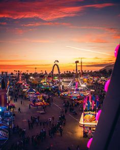 an aerial view of a carnival at sunset