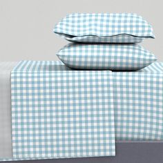 the blue and white checkered sheets are stacked on top of each other with matching pillow cases