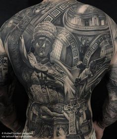 the back of a man's full body with many tattoos on his upper and lower half