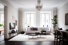 a living room filled with furniture and a chandelier