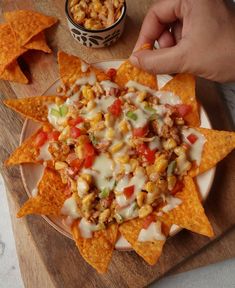 a plate full of nachos and corn chips