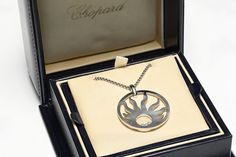 Chopard Sun Pendant.Chopard Happy Sun 18K white gold diamond pendant necklace with original Chopard box. Chain Length 16.5 inches. Pendant measures 1.57" 1.37". 40 mm by 34 mm. Weight 24.5 Grams. Signed Chopard 750 and serials numbers. Luxury Platinum Necklaces As A Gift, Modern Platinum Necklace As Gift, Modern Platinum Necklaces As Gift, Platinum Necklaces With Polished Finish As A Gift, Polished Platinum Necklace As A Gift, Gold Diamond Pendant Necklace, Happy Sun, Sun Pendant, Montblanc Pen