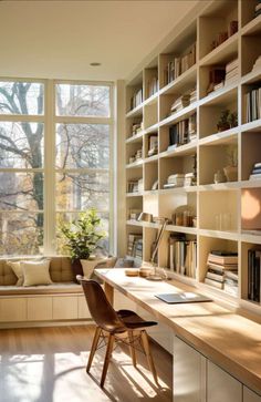 a home office with bookshelves full of books and a desk in front of a window