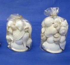 three small white figurines in plastic bags