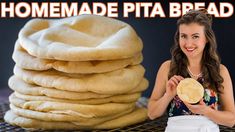 a woman standing next to stacks of pita bread on a cooling rack with the words homemade pita bread